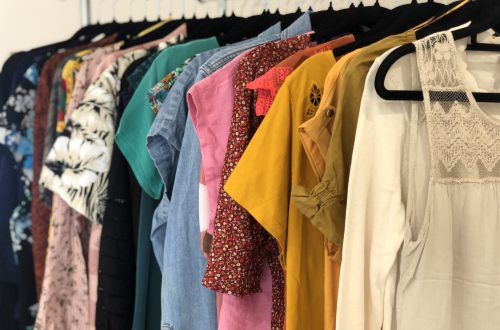 Clothes rack displaying many colorful women's or femme tops.