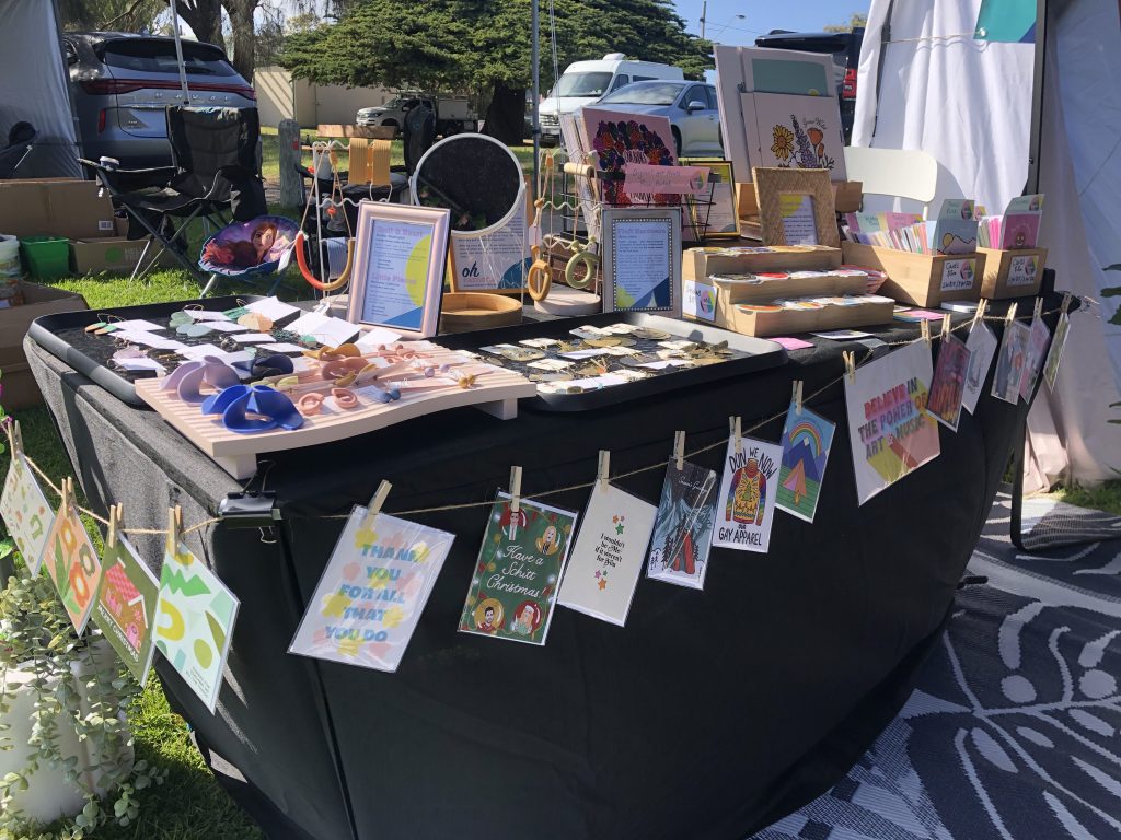 A market stall table packed with goods for sale.